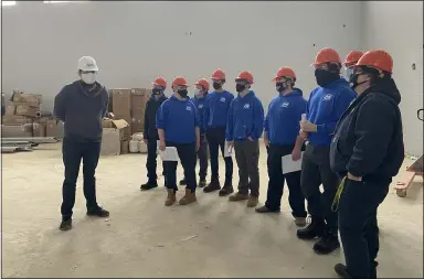  ?? LYRIC AQUINO — THE MORNING JOURNAL ?? Lorain County JVS HVAC students tour the new elementary school in Oberlin.