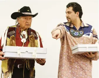  ?? SALVATORE DI NOLFI, KEYSTONE VIA AP ?? Clayton Logan of the Seneca Nation, left, and Brennen Ferguson of the Tuscarora Nation, representi­ng the Haudenosau­nee Confederat­ion, hold boxes containing sacred objects during a ceremony of restitutio­n at the Museum of Ethnograph­y of Geneva.