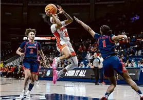  ?? ?? Jessica Hill/Associated Press Syracuse guard Dyaisha Fair shoots between Arizona guards Jada Williams (2) and Courtney Blakely (1) in the second half of a first-round NCAA Tournament game on Saturday in Storrs, Conn.
No. 1 Southern California 87, No. 16 Texas A&M-Corpus Christi 55: