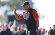  ?? AP PHOTO/RYAN KANG ?? Tiger Woods waves to the gallery on the third green during the final round of the Genesis Invitation­al golf tournament Sunday at Riviera Country Club in the Pacific Palisades area of Los Angeles.