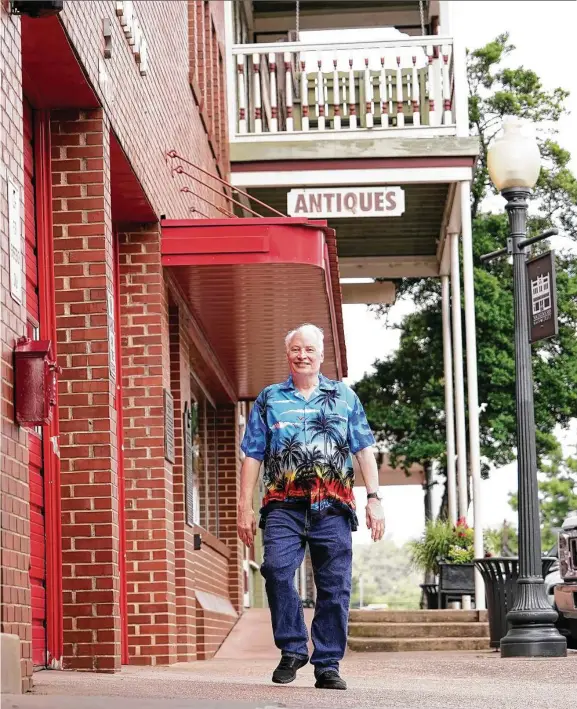  ??  ?? Top: Author Joe R. Lansdale walks the streets of Nacogdoche­s. Above: Lansdale points out his name engraved on a brick in the town square.