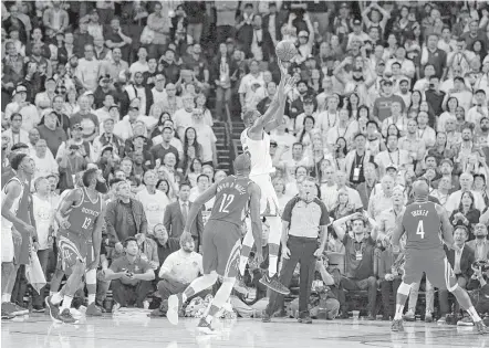  ?? Carlos Avila Gonzalez / San Francisco Chronicle ?? Had this shot by Kevin Durant, center, counted, the Warriors would have pulled out a win at the end. However, it was ruled to have come too late to beat the buzzer upon video review, thus giving the Rockets a big opening victory at Oracle Arena on...