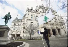  ?? Brian A. Pounds / Hearst Connecticu­t Media ?? Duncan Lemp, of Norwich, was one of a small number of pro and anti-Trump protesters to show up outside the Capitol in Hartford.