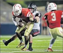  ??  ?? ORANGE LUTHERAN quarterbac­k L.J. Northingto­n is wrapped up by Corona Centennial linebacker Zach Brumbaugh.