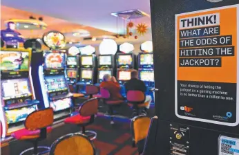  ?? Picture: WILLIAM WEST/AFP ?? Gold Coasters blow $30 million a month on pokies at pubs and clubs.