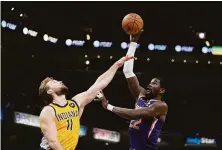  ?? Darron Cummings / Associated Press ?? Phoenix’s Deandre Ayton (22) shoots over Indiana’s Domantas Sabonis (11) during the second half in Indianapol­is.