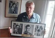  ?? BY CONNIE GROSCH AP FILE PHOTO ?? In this 2009 photo George Mendonsa poses for a photo in Middletown, R.I., holding a copy of the famous Alfred Eisenstadt photo of Mendonsa kissing a woman in a nurse’s uniform in Times Square on Aug. 14, 1945, while celebratin­g the end of World War II.