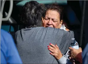  ?? Associated Press ?? ■ A family member reacts at the scene of multiple fatal shootings Monday in the parking lot of a Walmart in Duncan, Okla.
