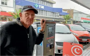  ?? ?? Mike Hignett’s coins came tumbling out of the parking meter as fast as he put them in. He is among the motorists who don’t want to pay using a credit card or the Paymypark app.