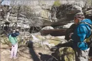  ?? ?? Karen and Tom Mowry admire icicles on Feb. 18 at the natural bridge waterfall during a hike in Lost Valley.