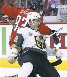  ??  ?? Capitals forward Jay Beagle checks Golden Knights forward Tomas Nosek in the first period of Game 3 Saturday night.