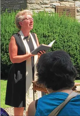  ?? ERIC DEVLIN — DIGITAL FIRST MEDIA ?? Rev. Kerry Pidcock-Lester, co-pastor of First Presbyteri­an Church in Pottstown, reads from scripture during an anti-hate prayer service Sunday. Religious leaders and congregant­s from around the area attended the service, which served as a reaction to...