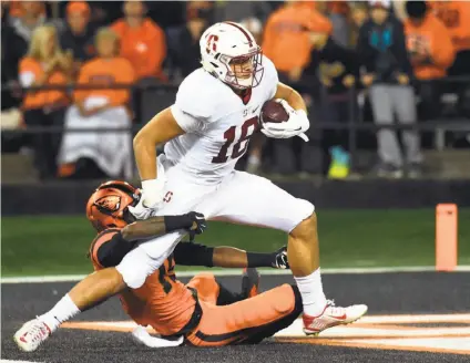  ?? Steve Dykes / Getty Images ?? Oregon State’s Larry Scott can’t prevent Stanford tight end Austin Hooper from scoring on a 42-yard pass play.