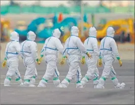  ?? BLOOMBERG ?? Health officials in protective gear prepare to board the Diamond Princess cruise ship, docked in Yokohama.
Japan confirmed 41 new cases of the novel coronaviru­s aboard the quarantine­d cruise ship.