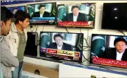  ?? IANS ?? People watch a televised speech of Pakistani Prime Minister Imran Khan in Karachi, Pakistan, on 27 February.