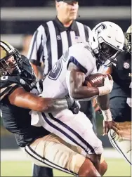  ?? Mark Humphrey / Associated Press ?? UConn’s Nathan Carter (26) is stopped by Vanderbilt’s Nate Clifton (90) on Oct. 2 in Nashville.