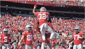  ?? JOSHUA A. BICKEL/COLUMBUS DISPATCH ?? Ohio State Buckeyes running back Treveyon Henderson (32) celebrates with teammates after scoring a touchdown during the second quarter of Saturday’s game against Maryland.