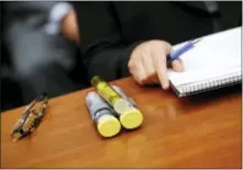  ?? PABLO MARTINEZ MONSIVAIS - THE ASSOCIATED PRESS ?? In this Sept. 21, 2016, photo, EpiPens brought by Mylan CEO Heather Bresch are seen on Capitol Hill in Washington as she testified before the House Oversight Committee hearing on EpiPen price increases. Senators are asking the Justice Department to...