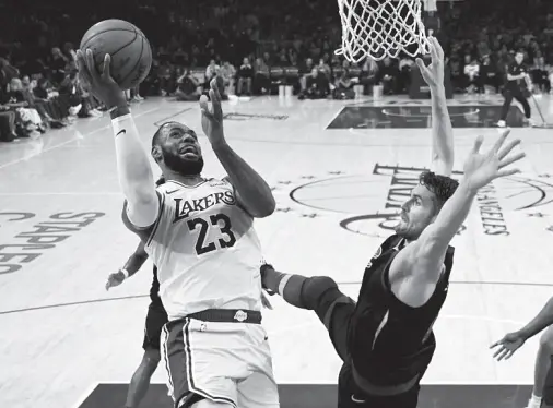  ?? (AP Photo/Mark J. Terrill) ?? LOS ANGELES Lakers forward LeBron James, left, shoots as Cleveland Cavaliers forward Kevin Love defends during the first half of an NBA basketball game Monday, Jan. 13, 2020, in Los Angeles.