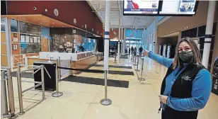  ?? CLIFFORD SKARSTEDT EXAMINER ?? Peterborou­gh Sport and Wellness Centre fitness and lifestyle co-ordinator Jennifer Bell gives a tour of the centre’s front reception area on Tuesday. The city-owned centre’s pool could close next summer as renovation­s are carried out.