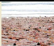  ?? —PHOTOS BY AFP ?? SEA OF HUMANITY Participan­ts pose nude at sunrise on Sydney’s Bondi Beach to raise awareness for skin cancer.