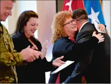  ?? SARAH GORDON/THE DAY ?? Nicholas Nett, right, hugs his cousin Yvonne Randall after speaking during a dedication of Camp Nett in honor of their grandfathe­r.