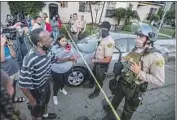  ?? Robert Gauthier Los Angeles Times ?? RESIDENTS face off with sheriff ’s deputies Monday after the killing of Dijon Kizzee in South L.A.