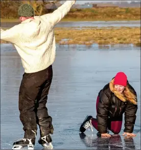  ??  ?? BALANCING ACT: A skater takes a tumble on a frozen fen in Ely yesterday