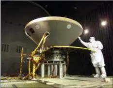  ?? NASA — JPL-CALTECH — LOCKHEED MARTIN VIA AP ?? In this 2015 photo made available by NASA, a technician prepares the InSight spacecraft for thermal vacuum testing in its “cruise” configurat­ion for its flight to Mars, simulating the conditions of outer space at Lockheed Martin Space Systems in Denver.