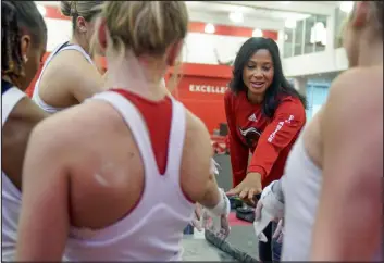  ?? SETH WENIG — THE ASSOCIATED PRESS ?? Rutgers women’s gymnastics coach Umme Salim-beasley joins a huddle during a practice at Rutgers in Piscataway, N.J., on March 2. The Supreme Court’s decision to overturn Roe vs. Wade has added another complicate­d layer for college coaches to navigate.