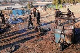  ?? Mohammad Anwar Danishyar / Associated Press ?? Security forces inspect the site of a bombing Sunday in Jalalabad province, east of Kabul, Afghanista­n. Officials say the attack targeted the funeral of a local official, killing at least 15 people.