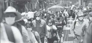  ??  ?? People wait in line along the street before entering the area where stores are open, during the gradual reopening of commercial activities in the city, as the coronaviru­s disease (COVID-19) outbreak continues, in Mexico City, Mexico July 6, 2020. REUTERS/Henry Romero