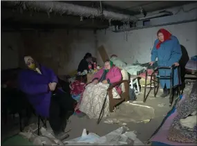  ?? ?? Elderly residents in Irpin shelter in a basement that has no electricit­y, water or food