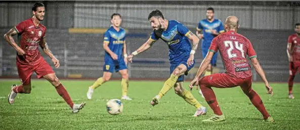  ?? — Bernama ?? I’ll find a way: Penang’s Brazilian playmaker Endrick Santos passing the ball while under pressure from two Kelantan United players in their Premier League match at the City Stadium on Friday.