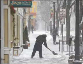  ?? PETE BANNAN – DIGITAL FIRST MEDIA ?? Celestin Estrada clears snow in front of Jaco Juice Bar in West Chester Thursday afternoon. Most people stayed home to avoid the Nor’easter storm.