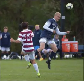  ?? PETE BANNAN — DIGITAL FIRST MEDIA ?? Episcopal Academy forward Sam Wilson heads the ball away from Haverford School’s Mitchell Hark. Wilson scored twice against the Fords that day, part of a 21-goal season.