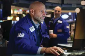  ?? (AP/Seth Wenig) ?? Traders work Wednesday on the floor at the New York Stock Exchange.