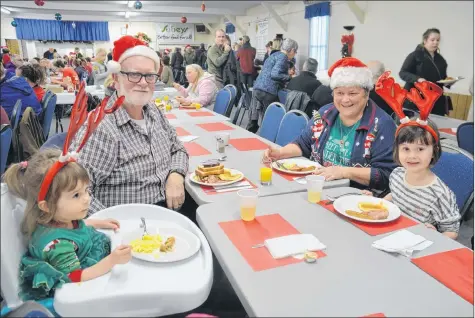  ?? KIRK STARRATT ?? Arnold and Joann Hudson, of Kingston, were enjoying the Kingston Lions Christmas Eve breakfast with their granddaugh­ters, two-year-old Eloise, left, and five-year-old Claudia Crepeau, of Halifax.