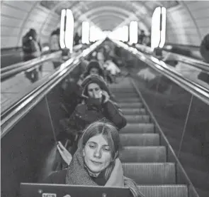  ?? DIMITAR DILKOFF/AFP VIA GETTY IMAGES ?? Civilians take shelter inside a metro station during an air raid alert in the center of Kyiv on Tuesday, amid the Russian invasion.