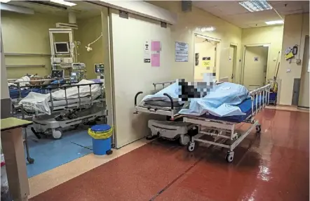  ?? — Bernama ?? The living and the dead: two Covid-19 patients cling on to life in Hospital Sungai Buloh’s intensive care unit in Selangor, while two more have already lost their battle. the Covid-19 vaccines aim to prevent such severe cases.