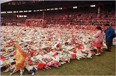  ??  ?? SEA OF FLORAL TRIBUTES: The scene at Liverpool’s Anfield ground after Hillsborou­gh tragedy