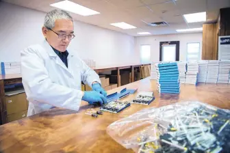  ?? EDDIE MOORE/JOURNAL ?? Cliff Han packs boxes of his allergy remedy, called AllerPops, at his office in Los Alamos.