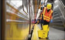  ?? JOHN MINCHILLO / AP ?? Workers clean subway cars at the 96th Street station in New York City to try to control the spread of COVID-19. Mass transit systems around the world have taken unpreceden­ted and expensive steps to curb the spread of the coronaviru­s.