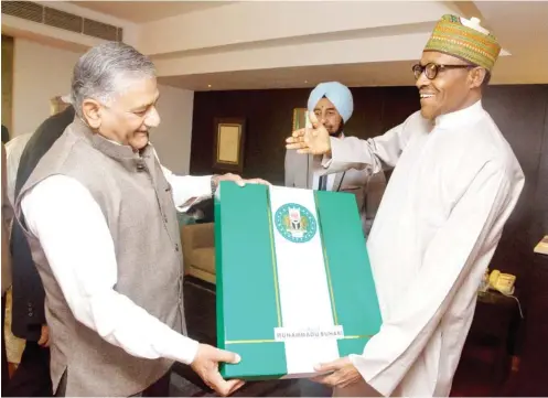  ?? Photo: State House ?? President Muhammadu Buhari (right), presents a gift to Gen. Vijay Kumar Singh, during his meeting with Gen. Singh and some of his senior Alumni, during the 3rd India-Africa Forum Summit, in New Delhi, India yesterday.