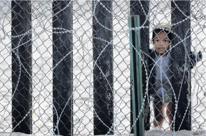  ?? PHOTO: REUTERS ?? Off limits . . . A child on the Mexico side looks through the border wall towards the United States at Border Field State Park in San Diego, California.