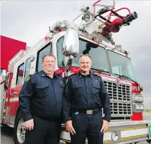  ?? GAVIN YOUNG ?? Deputy fire chief Allan Ball, left and fire district Chief Jeff Primrose were “incredibly proud” of the 52 local firefighte­rs who worked shifts this week to battle the Kenow wildfire in Waterton Lake National Park.