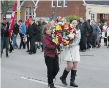  ?? FILES ?? Silver Kuris and her brother Liam carry a large wreath during last year’s National Day of Mourning service in Windsor. Their father Sam was killed on the job and Silver read an emotional poem about losing her dad.