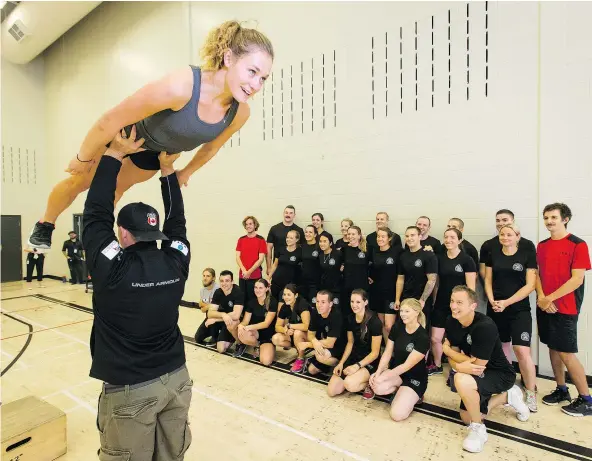  ??  ?? For national team ski jumper Taylor Henrich and head coach Gregor Linsig, shown demonstrat­ing a training drill, much of the work on the road to the 2018 Winter Olympics is done in the summer months. — POSTMEDIA NEWS FILES