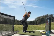  ?? Lea Suzuki / The Chronicle ?? Song Hong of San Francisco wears a mask as he practices his swing on the driving range at the Presidio Golf Course.