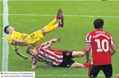  ??  ?? Glenn Loovens of Sunderland up-ends Jason Holt of Fleetwood